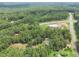 Aerial view showing home, pool, and surrounding woods at 2841 Upper Sweetwater Se Trl, White, GA 30184