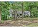 Ranch style home with wrap-around porch, surrounded by mature trees at 2841 Upper Sweetwater Se Trl, White, GA 30184