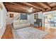 Living room with hardwood floors, exposed beams, and view into kitchen area at 2841 Upper Sweetwater Se Trl, White, GA 30184