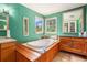 Bathroom with a built-in soaking tub, wooden surround, and a large mirror at 2841 Upper Sweetwater Se Trl, White, GA 30184