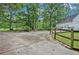 Long driveway with a wooden fence and landscaping at 2841 Upper Sweetwater Se Trl, White, GA 30184