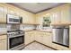 Kitchen with stainless steel appliances and light-colored cabinets at 2841 Upper Sweetwater Se Trl, White, GA 30184