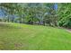 Landscaped yard with lush green grass and mature trees at 2841 Upper Sweetwater Se Trl, White, GA 30184