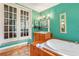 Bathroom with a soaking tub, French doors, and light teal walls at 2841 Upper Sweetwater Se Trl, White, GA 30184