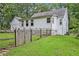 White house exterior with wooden fence and grassy area at 2841 Upper Sweetwater Se Trl, White, GA 30184