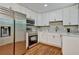 Bright kitchen boasts stainless steel appliances and white shaker cabinets at 163 Glenrose Sw Cir, Atlanta, GA 30354
