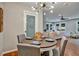 Bright dining area with round table, chandelier, and pantry access at 163 Glenrose Sw Cir, Atlanta, GA 30354