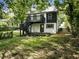 Two-story home with black and white exterior, deck, and landscaping at 1510 Mims Sw St, Atlanta, GA 30314