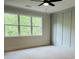 Bright bedroom with large window and ceiling fan at 2190 W Village Ln, Smyrna, GA 30080