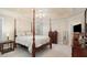 Main bedroom with a post bed, ceiling fan, and ample closet space at 109 Boulder View Trce # 0, Dallas, GA 30157