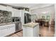 Modern kitchen with an island, stainless steel appliances, and stylish backsplash at 5365 Crow Rd, Cumming, GA 30041