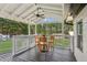 Relaxing covered porch with wood decking and seating area, overlooking backyard at 5365 Crow Rd, Cumming, GA 30041