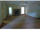 Spacious living room with a fireplace, ceiling fan, and carpeted floors at 9344 Hidden Hollow Trl, Jonesboro, GA 30236