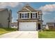 Two story house with tan siding, stone accents, and a two car garage at 254 Eva Way, Cartersville, GA 30121