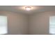 Bright bedroom with two windows and neutral walls at 1650 Bridgeport Nw Dr, Atlanta, GA 30318