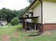 Side view of the house with basement access at 1650 Bridgeport Nw Dr, Atlanta, GA 30318