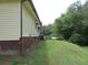 Side view of the house showing the exterior and yard at 1650 Bridgeport Nw Dr, Atlanta, GA 30318