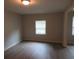 Well-lit bedroom featuring vinyl flooring and a window at 1650 Bridgeport Nw Dr, Atlanta, GA 30318