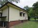 Side view of the house showcasing the exterior and yard at 1650 Bridgeport Nw Dr, Atlanta, GA 30318