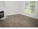 Living room with fireplace and wood-look flooring at 15 Marissa Cv, Riverdale, GA 30274
