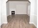 Living room with corner fireplace and wood-look flooring at 15 Marissa Cv, Riverdale, GA 30274