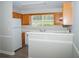 Kitchen boasts wood cabinets, white appliances, and a breakfast bar at 15 Marissa Cv, Riverdale, GA 30274