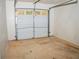 Attached garage with overhead door and ample storage space at 15 Marissa Cv, Riverdale, GA 30274