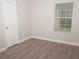 Well-lit bedroom with hardwood floors and a large window at 15 Marissa Cv, Riverdale, GA 30274