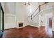 Two-story Gathering room with hardwood floors, fireplace, built-in shelving, and a stunning staircase at 3591 Reevley Ln, Tucker, GA 30084