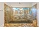 Large walk-in shower with glass enclosure, tiled walls, and built-in seat at 3591 Reevley Ln, Tucker, GA 30084