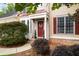 Brick front house with red door and nicely landscaped yard at 209 Vine Creek Drive, Acworth, GA 30101