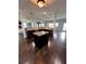 Open kitchen with island and breakfast bar, granite countertops, and dark cabinets at 190 Thrushwood Dr, Fayetteville, GA 30215