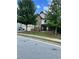 Two-story house with stone and vinyl siding, landscaping, and a large front yard at 190 Thrushwood Dr, Fayetteville, GA 30215