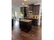 Island kitchen with granite countertops and dark wood cabinets at 190 Thrushwood Dr, Fayetteville, GA 30215
