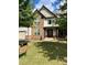 Two-story house with stone and vinyl siding, landscaping, and a large front yard at 190 Thrushwood Dr, Fayetteville, GA 30215