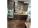 Modern kitchen with double ovens, granite countertops, and dark wood cabinets at 190 Thrushwood Dr, Fayetteville, GA 30215