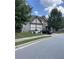 Two-story house with stone and vinyl siding, landscaping, and a large front yard at 190 Thrushwood Dr, Fayetteville, GA 30215