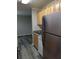 Modern kitchen boasts stainless steel fridge, light wood cabinets, and grey vinyl flooring at 2396 Lawrenceville Hwy # F, Decatur, GA 30033