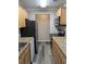 Kitchen with granite countertops, light wood cabinets, and modern appliances at 2396 Lawrenceville Hwy # F, Decatur, GA 30033