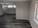 Dining area with wood-look floors and a chandelier at 2396 Lawrenceville Hwy # F, Decatur, GA 30033