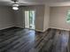 Living room with sliding glass door to balcony and vinyl flooring at 2396 Lawrenceville Hwy # F, Decatur, GA 30033