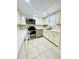Updated kitchen with white cabinets, stainless steel appliances, and tile floors at 307 Lakemoore Ne Dr # D, Atlanta, GA 30342