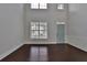 Bright living room with dark hardwood floors and large windows at 6640 Country Lake Rd, Cumming, GA 30041