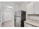 Kitchen boasts stainless steel refrigerator and granite countertops at 2259 Sisk Nw St, Atlanta, GA 30318