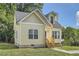 Charming yellow house with gray roof and landscaping at 2259 Sisk Nw St, Atlanta, GA 30318
