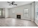 Living room featuring vinyl flooring, fireplace, and ceiling fan at 2259 Sisk Nw St, Atlanta, GA 30318