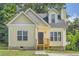 Cute yellow house with gray roof, small front porch, and landscaping at 2259 Sisk Nw St, Atlanta, GA 30318