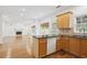 Kitchen with granite countertops, island, stainless steel appliances, and hardwood floors at 295 Vickery Way, Roswell, GA 30075