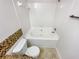 Clean bathroom with a bathtub, toilet, and tile flooring at 5319 Pinnacle Peak Ln, Norcross, GA 30071