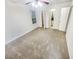 Bright bedroom featuring carpet, ceiling fan, and private bathroom access at 5319 Pinnacle Peak Ln, Norcross, GA 30071